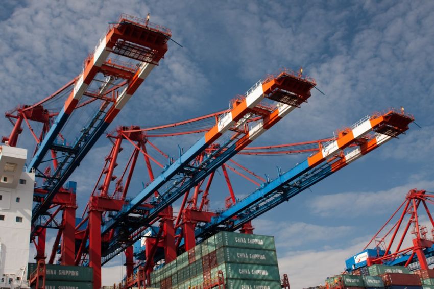 Global Trade - red and blue crane under blue sky during daytime