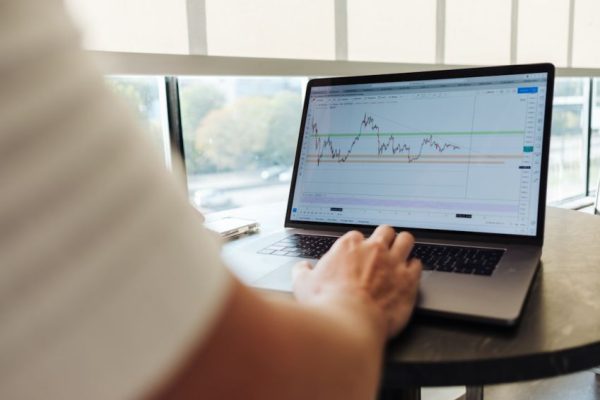Trading - person using MacBook Pro on table