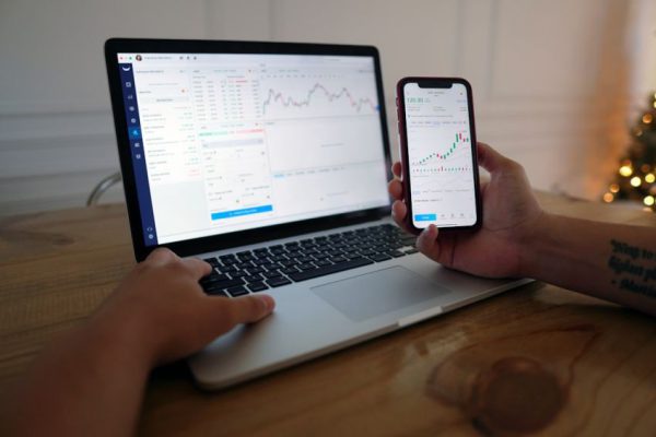 Stock Trading - macbook pro on brown wooden table