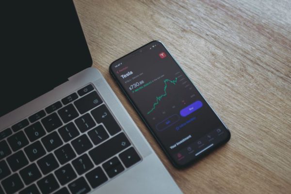 Stock Trading - black android smartphone on macbook pro