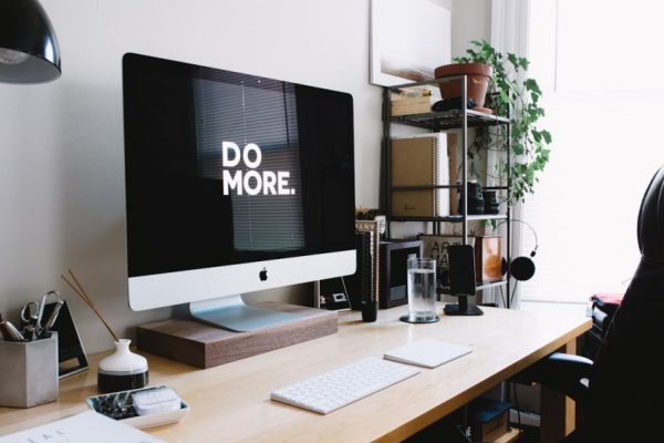 Stock Trading - silver iMac with keyboard and trackpad inside room