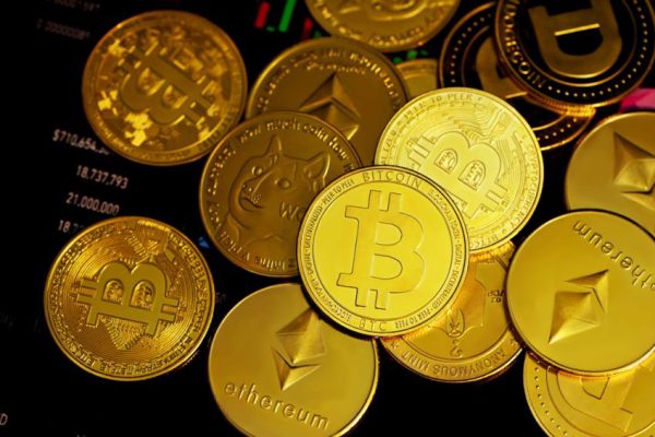 Cryptocurrency - a pile of gold bitcoins sitting on top of each other