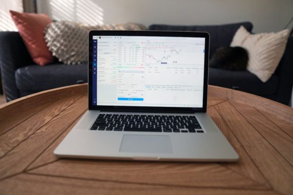 Stock Trading - macbook pro on brown wooden table