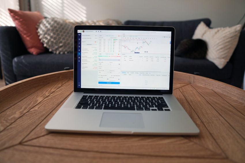 Stock Trading - macbook pro on brown wooden table
