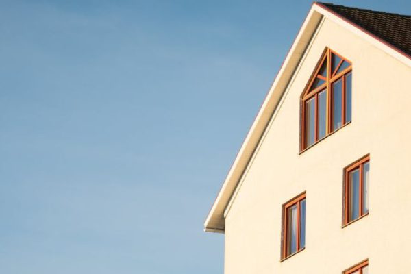 Investment - Beige Concrete House Under Cumulus Cloud