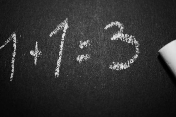 What Are the Common Mistakes in Trading Mistakes - 1 + 1 = 3 Text on Black Chalkboard