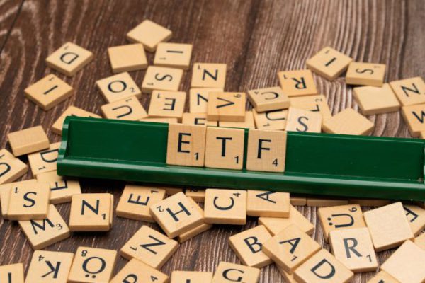 Diversification - The word etf on a wooden board with scrabble tiles
