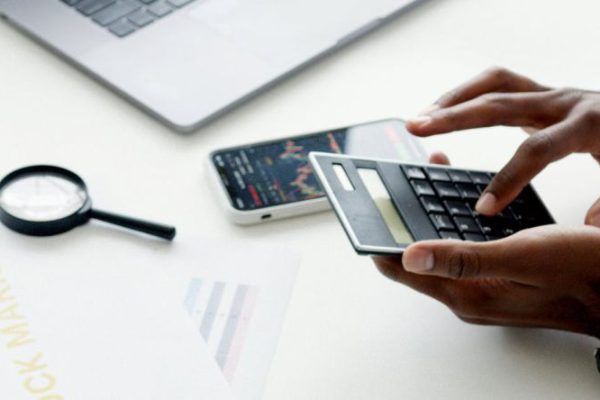 Stocks - Photo Of Person Using Calculator