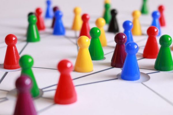 Strategies - Close Up Photography of Yellow Green Red and Brown Plastic Cones on White Lined Surface