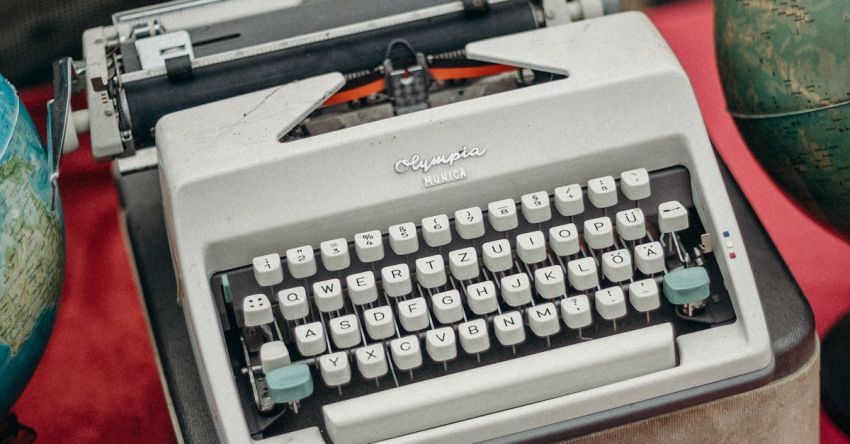 Swaps - Green and Gray Typewriter on Red Table