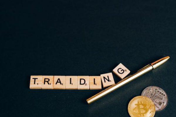 How Do Cryptocurrencies Differ from Traditional Currencies Cryptocurrencies - Traiding Sign by Pen and Coins